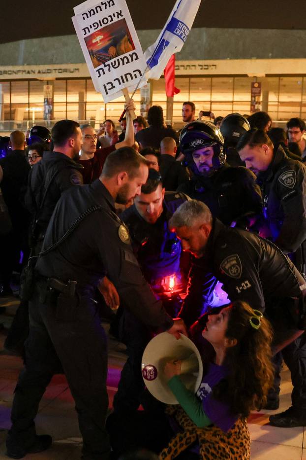 Israelis take part in an anti-war protest in Tel Aviv