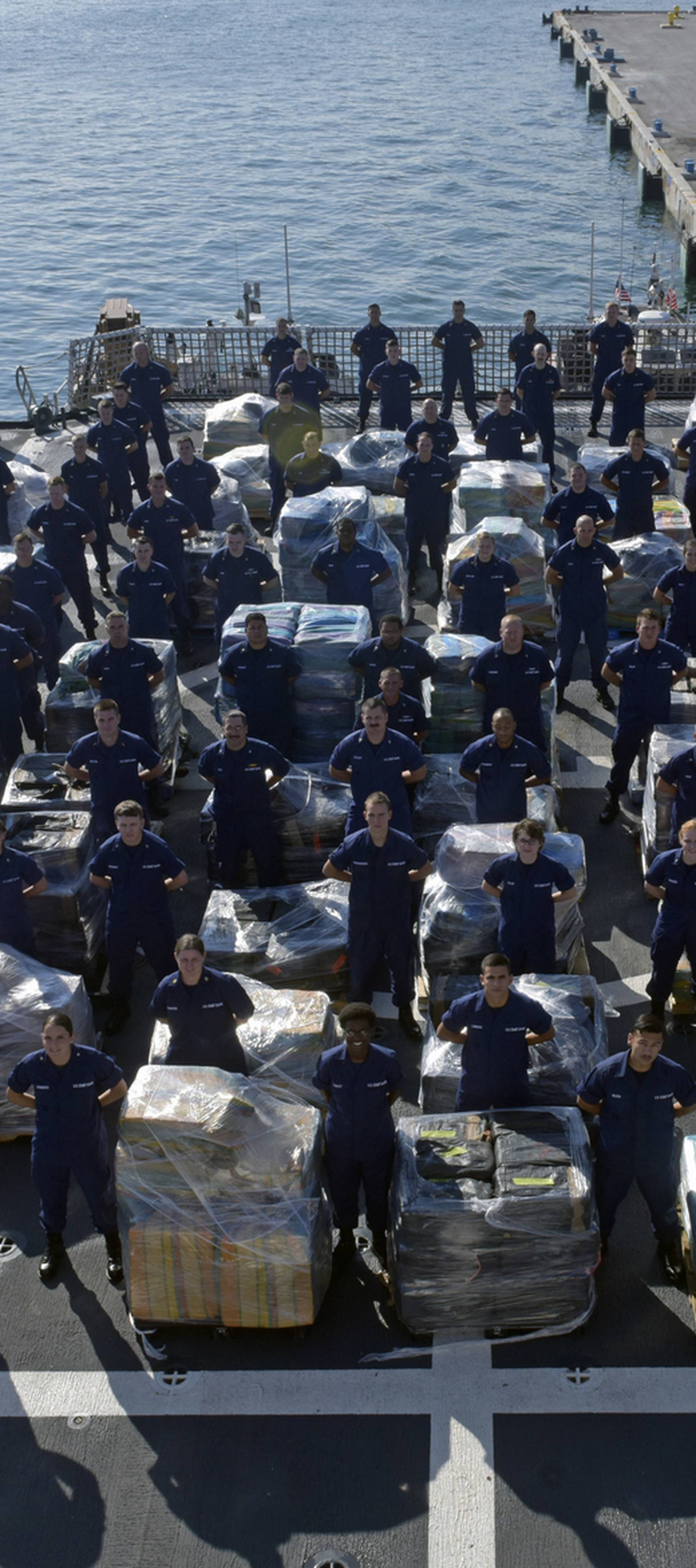 Coast Guard Cutter Hamilton crew stand next to 26.5 tons of cocaine