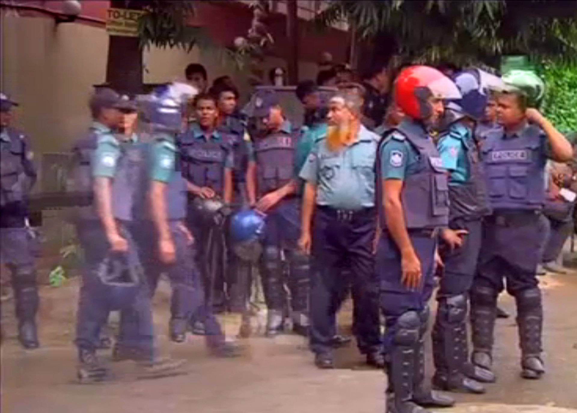 Still frame taken from video show police gathering after gunmen attacked the Holey Artisan restaurant and took hostages early on Saturday, in Dhaka
