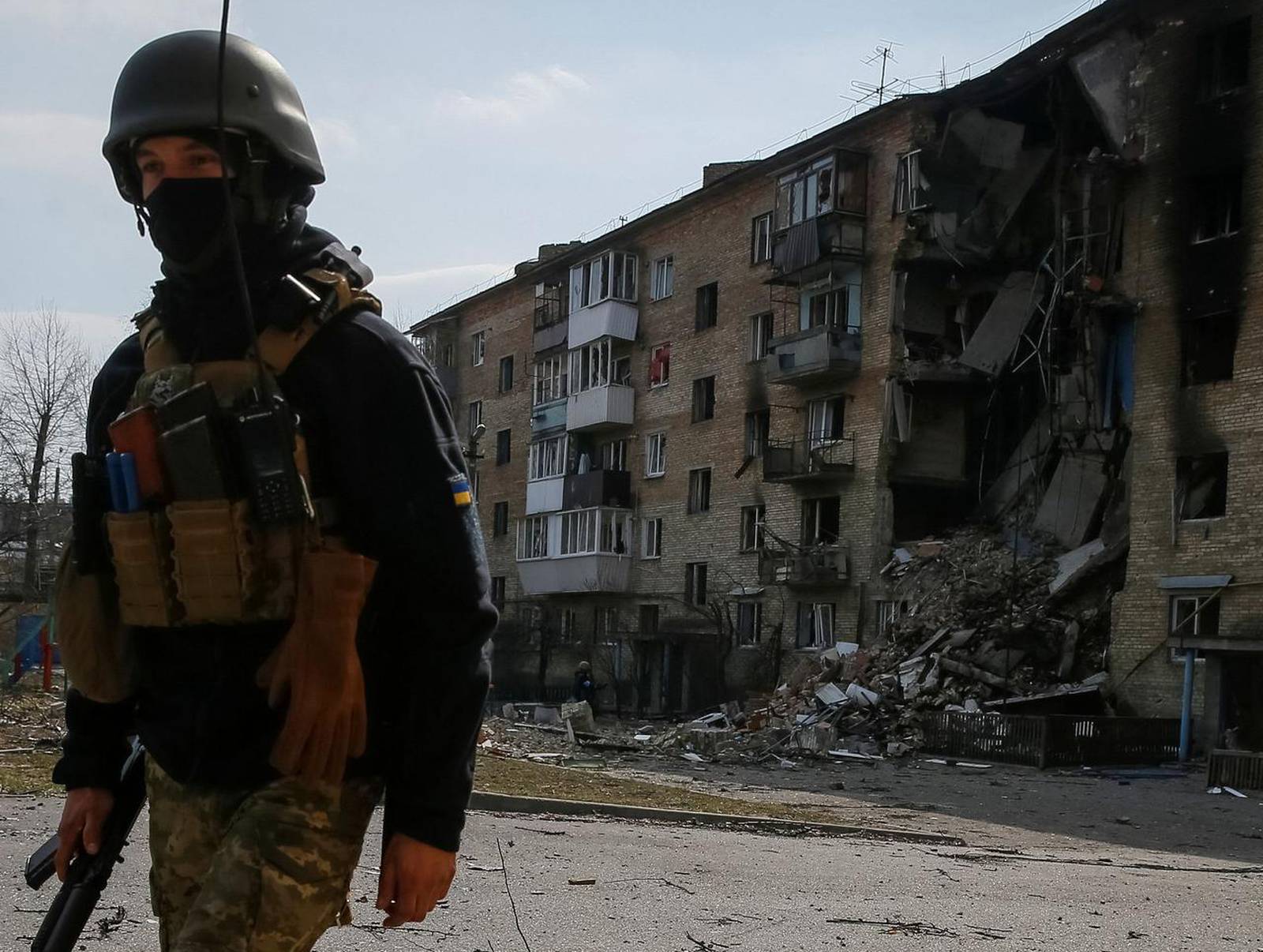 A Ukrainian service member walks on the front line near Kyiv