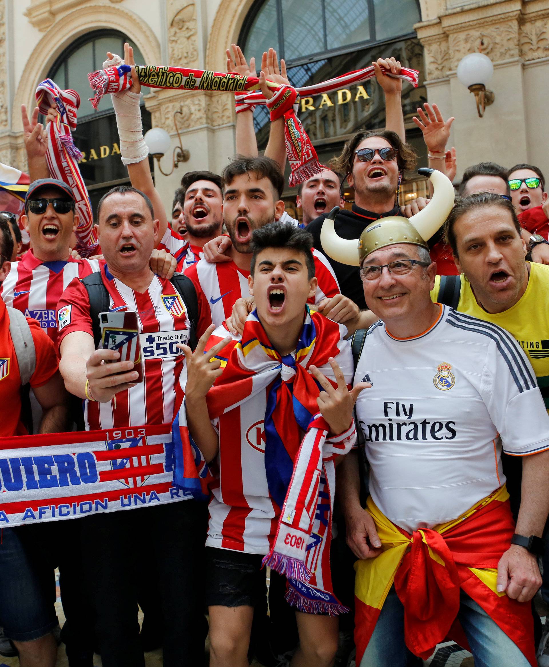 A Real Madrid fan poses with Atletico Madrid fans before the Champions League Final between Real Madrid and Atletico Madrid in Milan