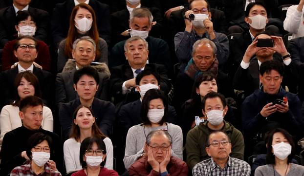 Visitors wearing surgical masks attend the opening ceremony of the Ariake Arena, which will host volleyball and wheelchair basketball competitions in Tokyo 2020 Olympic Games in Tokyo