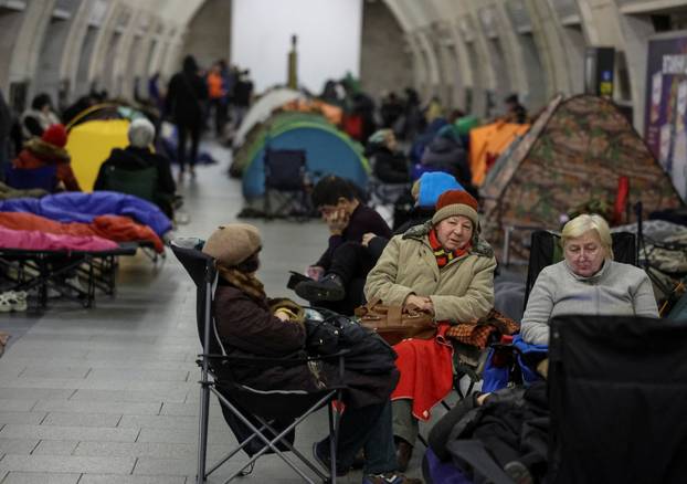 People take shelter inside a metro station during a Russian missile and drone attack in Kyiv