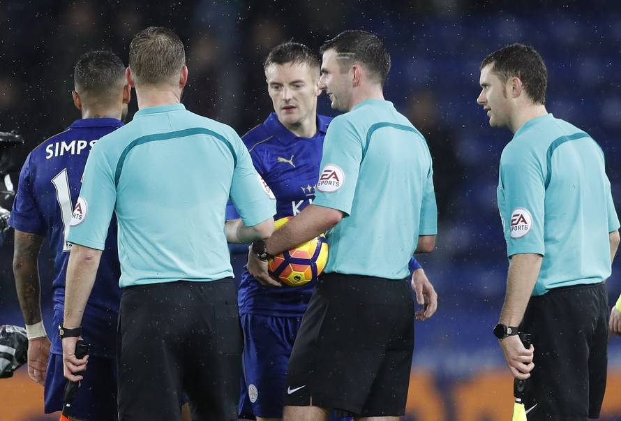 Leicester City's Jamie Vardy collets the match ball from the referee Michael Oliver at the end of the match after scoring a hat-trick