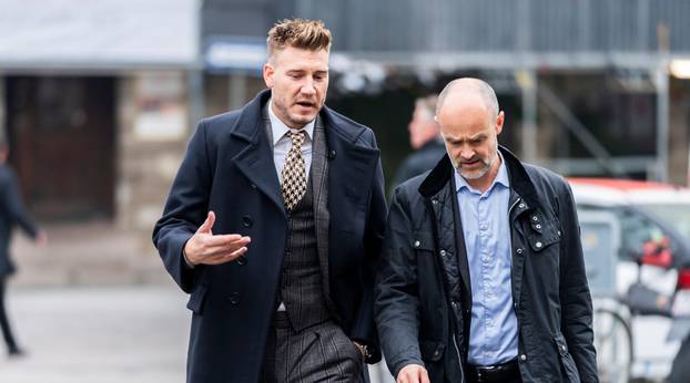 Denmark striker Nicklas Bendtner and lawyer Anders Nemeth arrive at the Copenhagen City Council