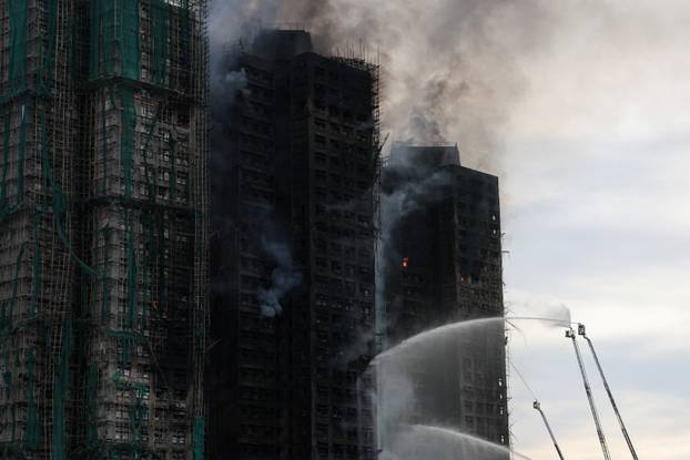 A general view shows the damaged towers of Wang Fuk Court housing estate, where a major fire engulfed bamboo scaffolding across multiple blocks, killing at least 44 people and leaving almost 300 missing, in Tai Po, Hong Kong