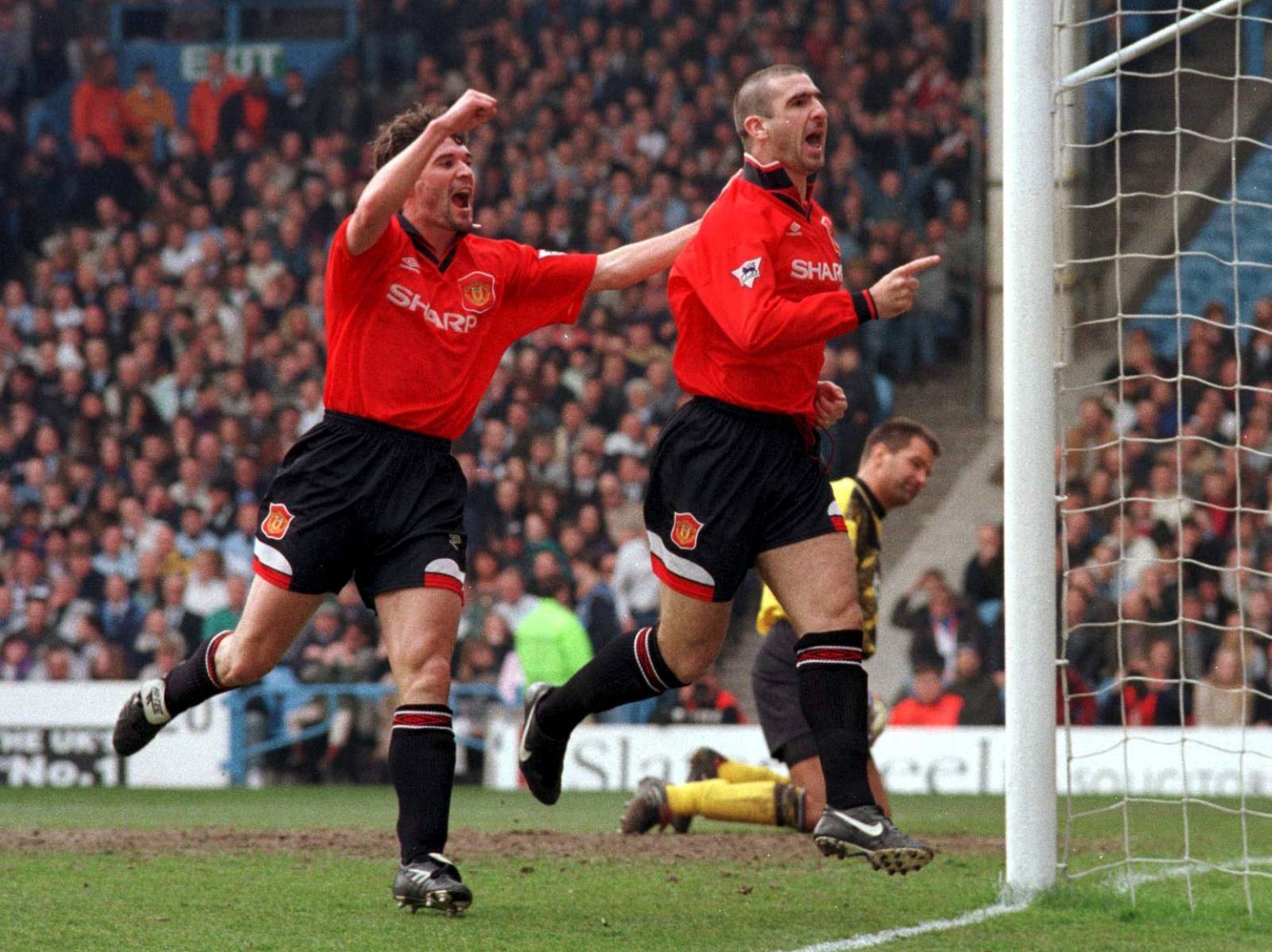 FILE PHOTO: Manchester United's Eric Cantona celebrates after scoring the opening goal from the penalty spot in a 3-2 Premier League win over Manchester City at Maine Road, Manchester.