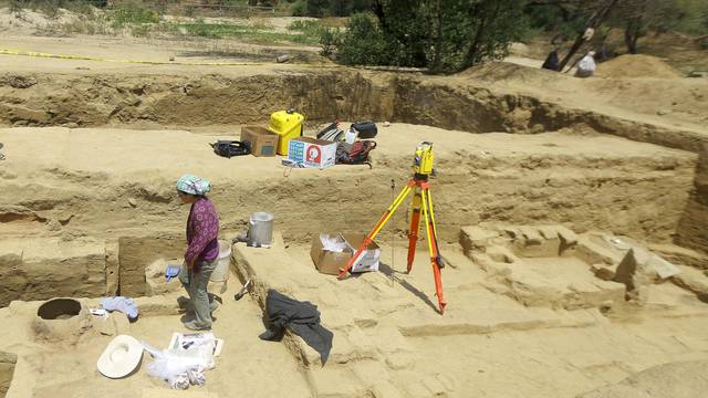 People stand at an archaeological site, where traces of human sacrifices over a thousand years ago, were recently discovered according to archaeologist Go Matsumoto,  at Huaca de la Cruz in the Pomac Forest Historic Sanctuary, in Lambayeque