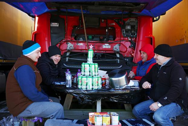 Lorry drivers from Poland sit around a table at a service station on the outskirts of Dover
