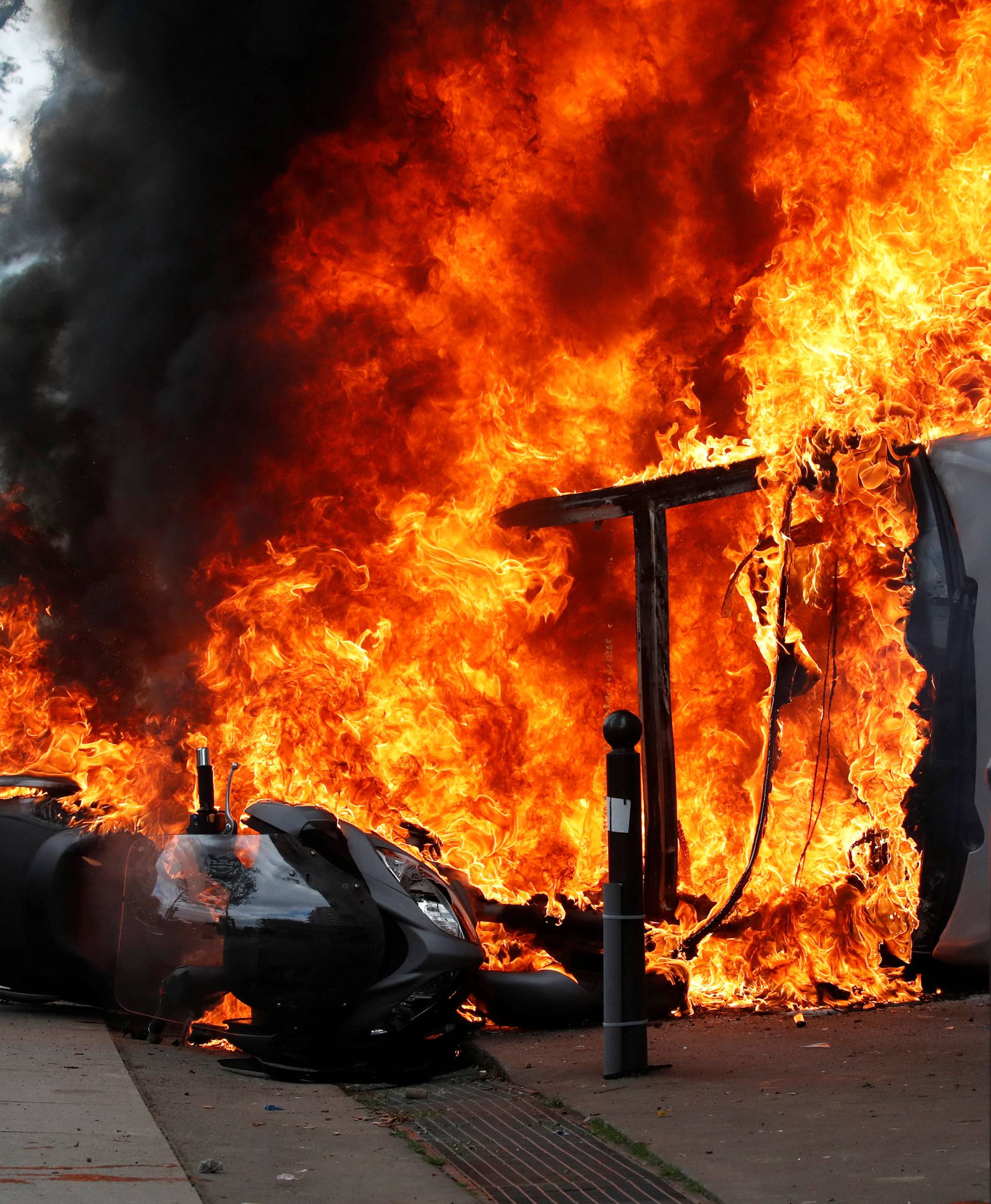 A car burns outside a Renault automobile garage during clashes at the May Day labour union march in Paris