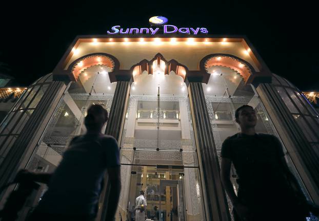 Egyption men stand infront of Sunny Days El Palacio hotel after an Egyptian man stabbed two German tourists to death and wounded four others in Hurghada, south of Cairo
