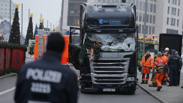 Police stand in front of the truck which ploughed last night into a crowded Christmas market in the German capital Berlin