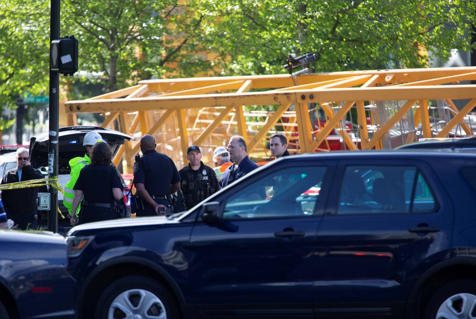 Seattle emergency personnel view part of a construction crane which fell onto cars and killed four people in Seattle