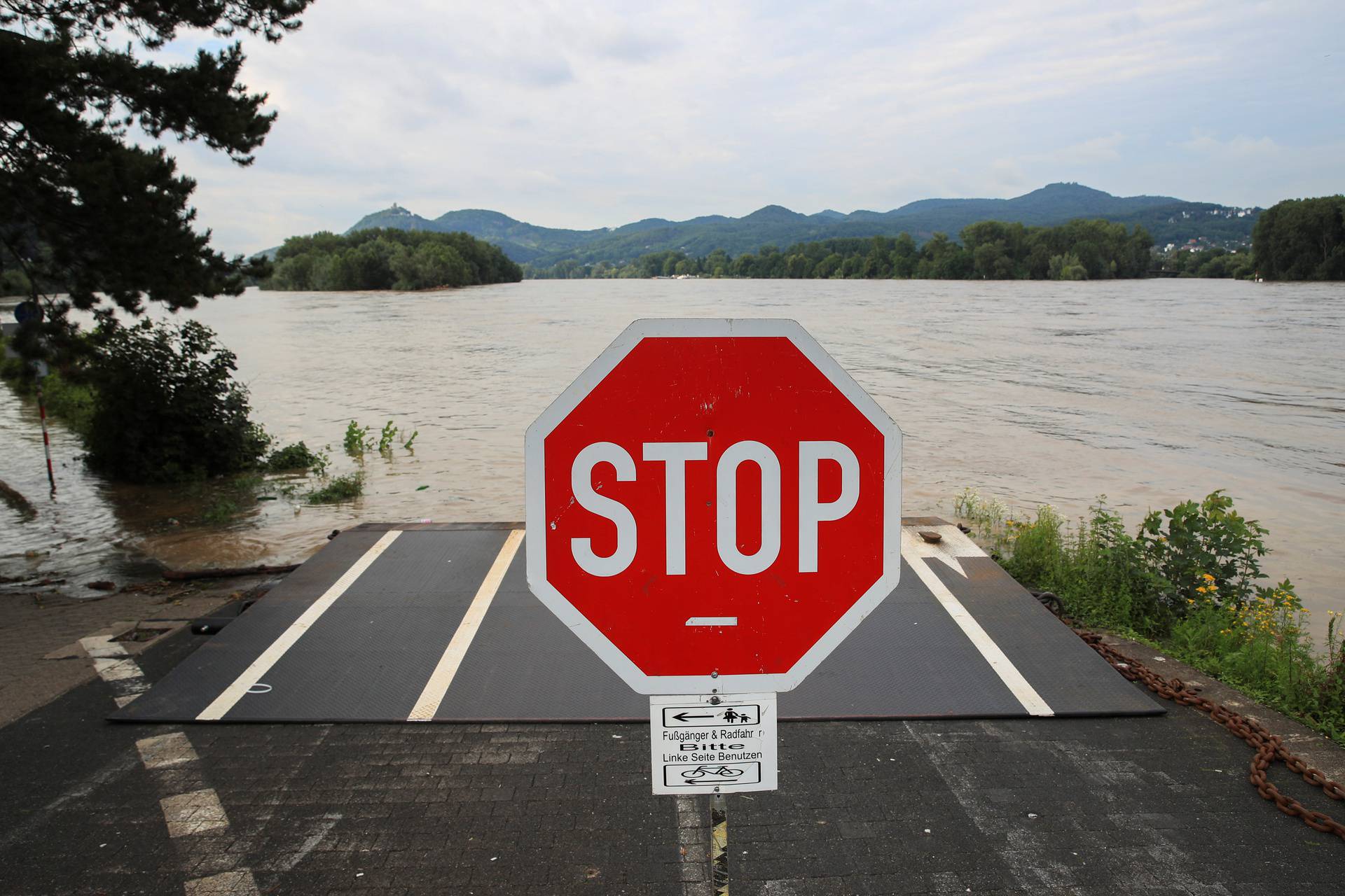 A Stop sign is pictured near a flooded area following heavy rainfalls in Rolandseck