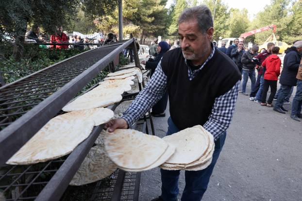 People queue to buy bread in Damascus