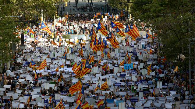 People hold placards and flag as they take part in a march of unity after the attacks last week, in Barcelona, Spain