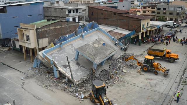 The debris of a collapsed house is cleared after an earthquake struck off the Pacific coast, in Guayaquil