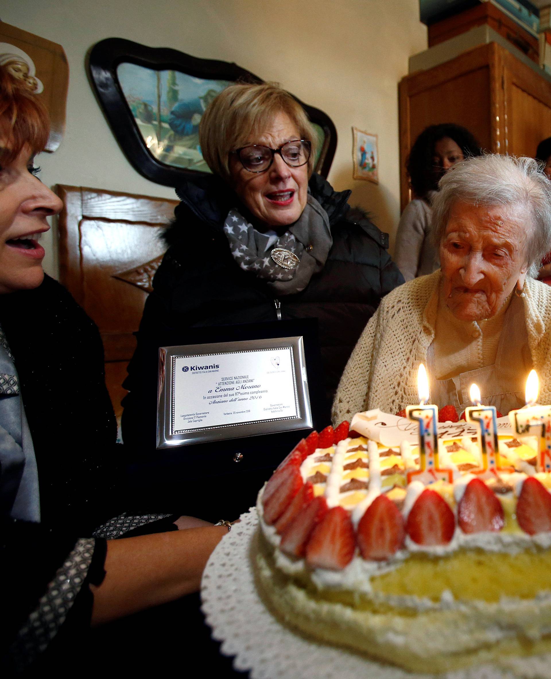 Emma Morano, thought to be the world's oldest person and the last to be born in the 1800s, reacts in front of her 117th birthday cake in Verbania