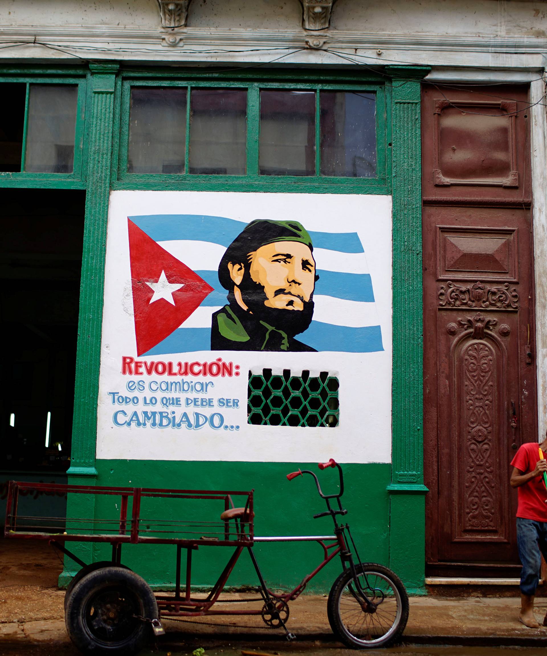 A painting depicting Cuba's late president Fidel Castro decorates a wall outside a subsidised state store in Havana