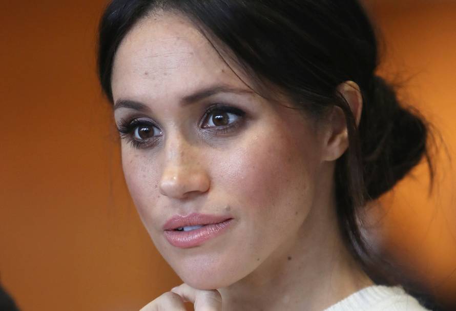 The fiancee of Britain's Prince Harry, Meghan Markle, reacts during a visit to a science park called Catalyst Inc., in Belfast