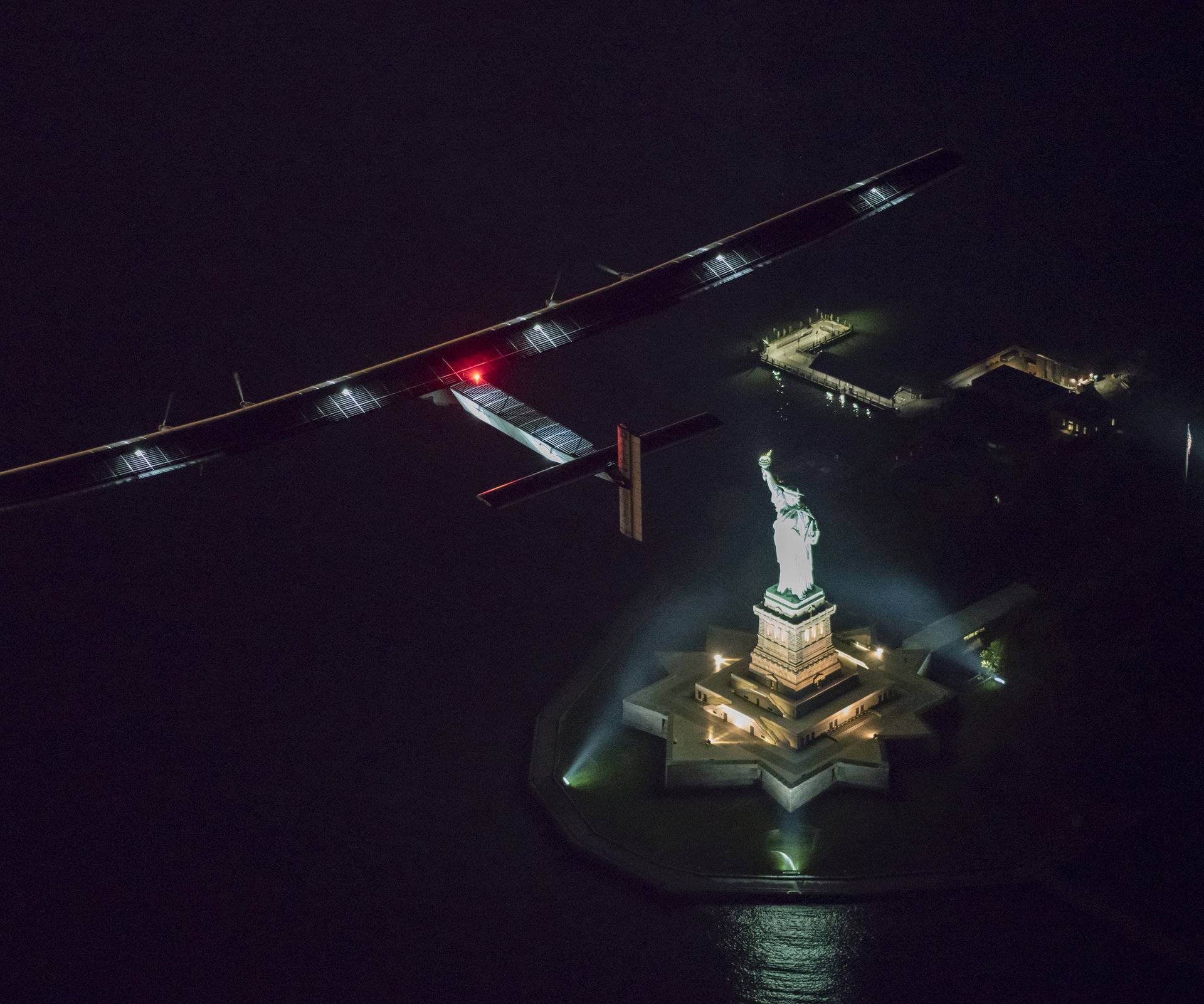 Solar Impulse 2, the solar airplane, piloted by Swiss adventurer Andre Borschberg, flies over the Statue of Libery in in New York, shortly before landing at John F. Kennedy airport