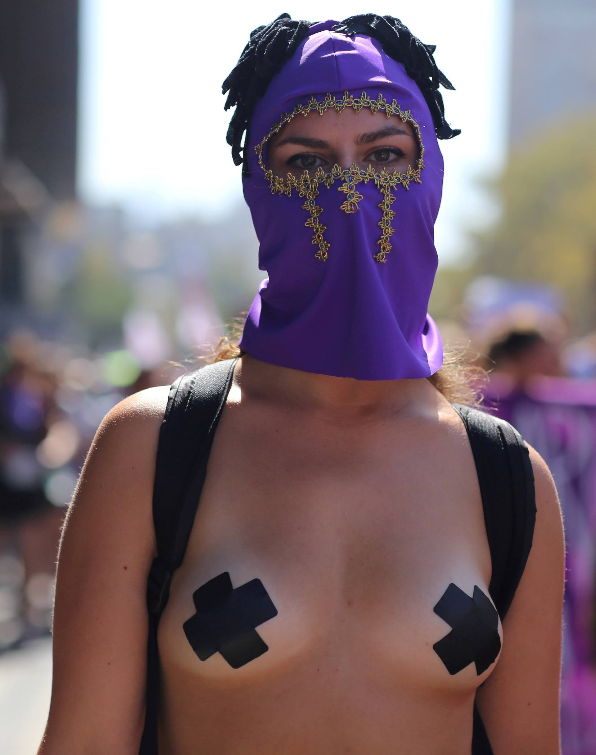 A woman takes part at a women's strike as part of International Women's Day activities in Santiago