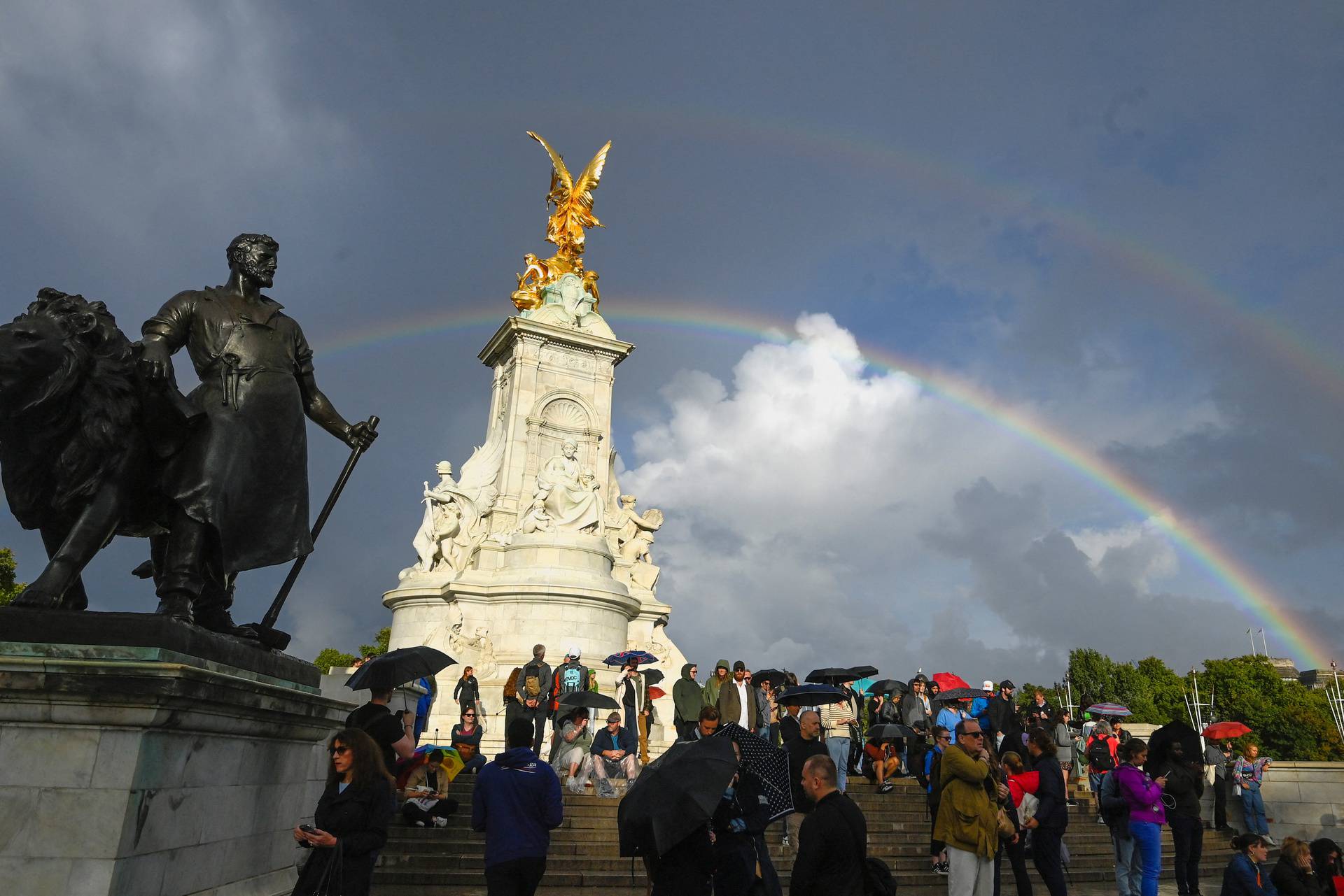 People gather outside Buckingham Palace in London