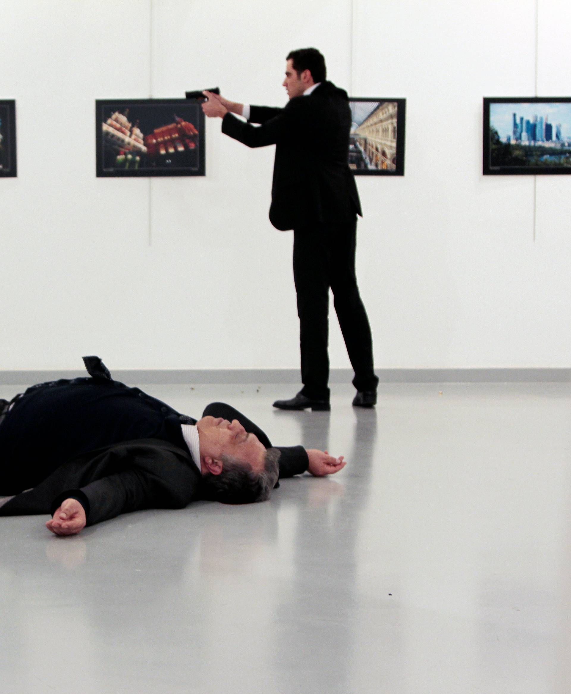 Russian Ambassador to Turkey Andrei Karlov lies on the ground after he was shot by Mevlut Mert Altintas at an art gallery in Ankara