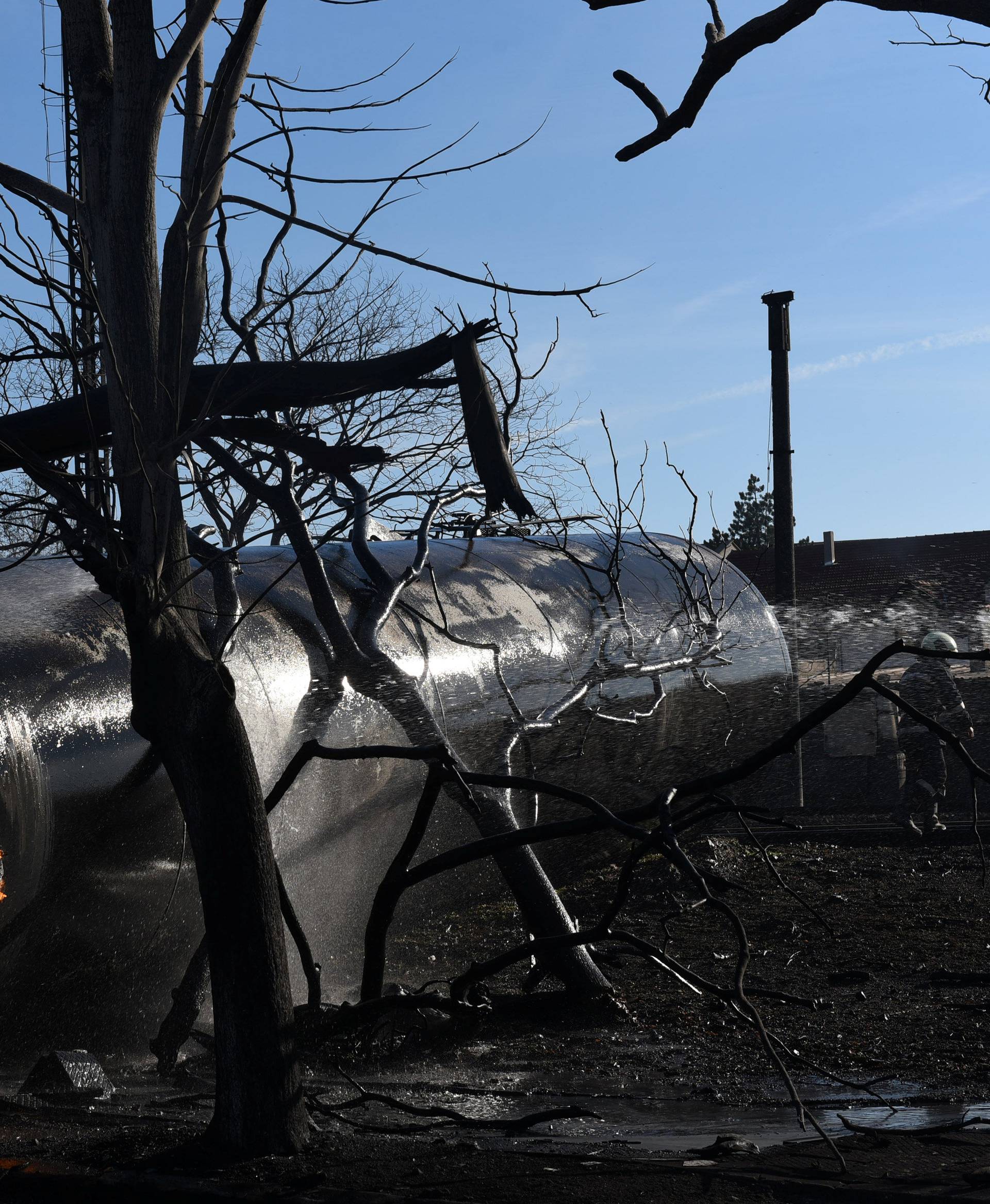 Firefighters work on the site where a cargo train derailed and exploded in the village of Hitrino