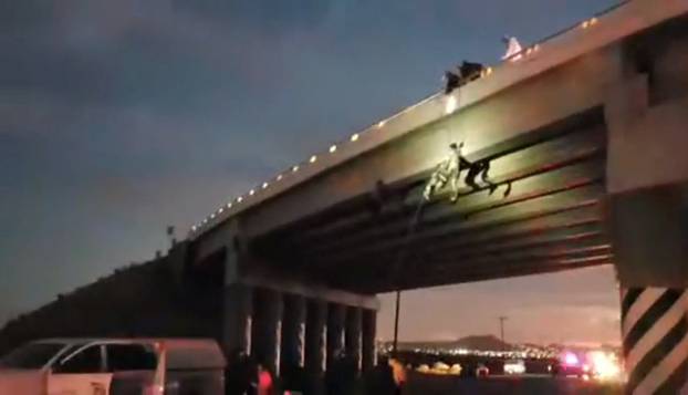 Rescuers remove two bodies hanged on the freeway to La Paz