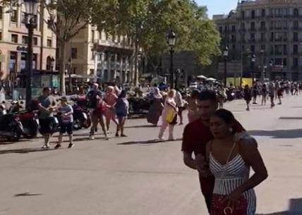 People run away after a van crashed into pedestrians near the Las Ramblas avenue in central Barcelona