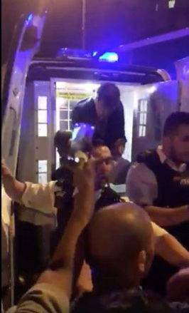Police officers put a man in the back of a police van after a vehicle collided with pedestrians in the Finsbury Park neighbourhood of North London