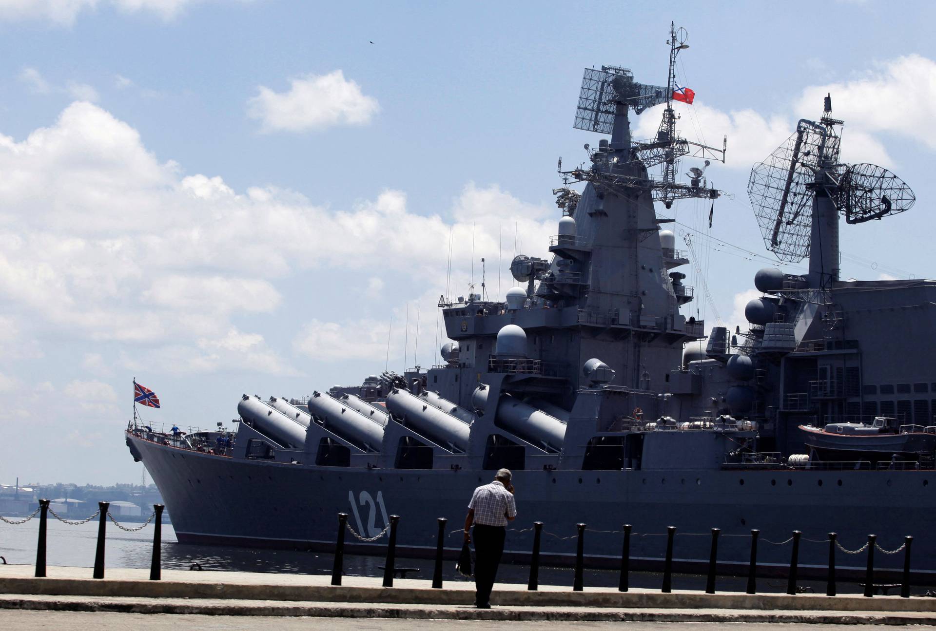 FILE PHOTO: A man walks beside the Russian Moskva Guided Missile Cruiser docked at Havana port