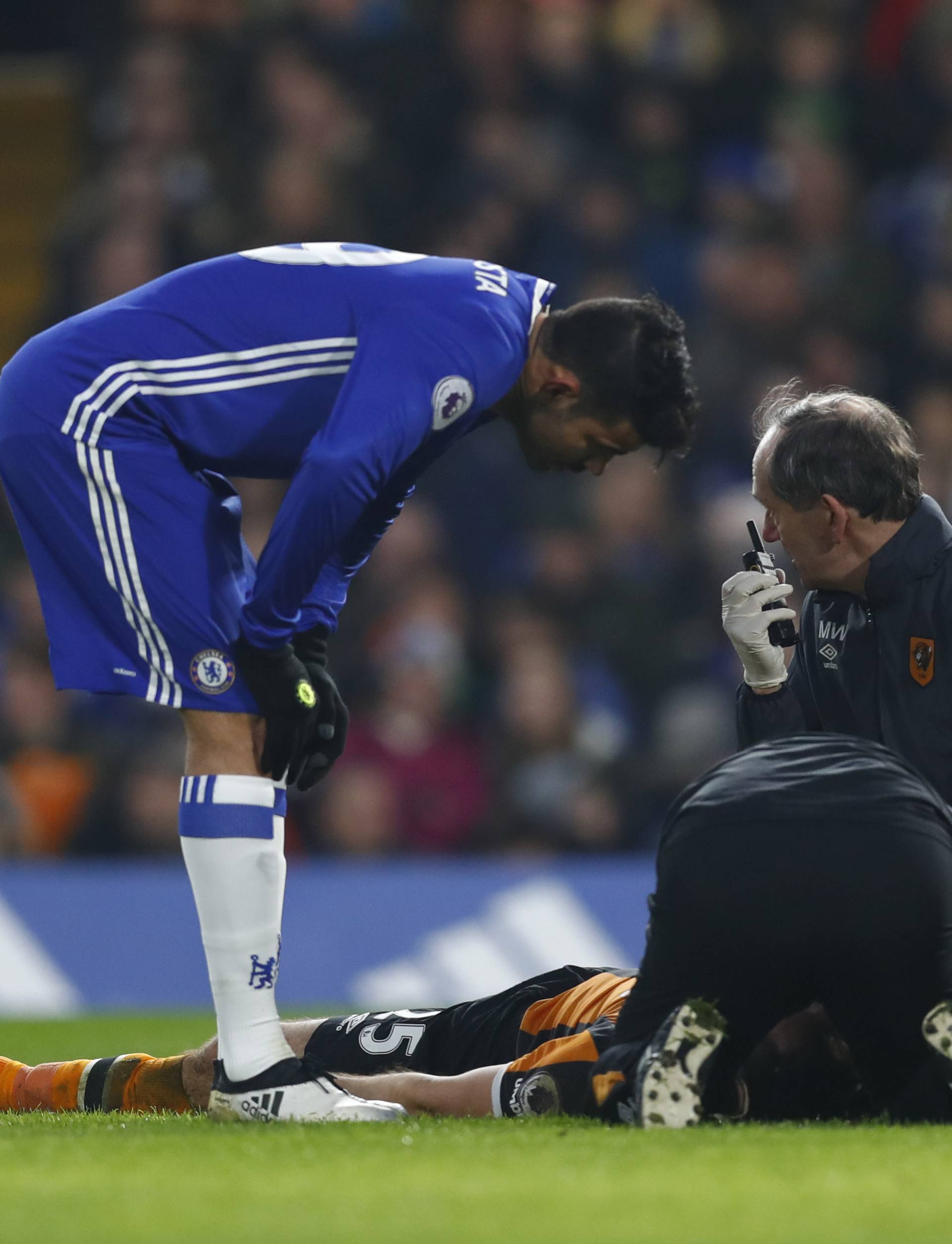 Chelsea's Diego Costa as Hull City's Ryan Mason lies injured
