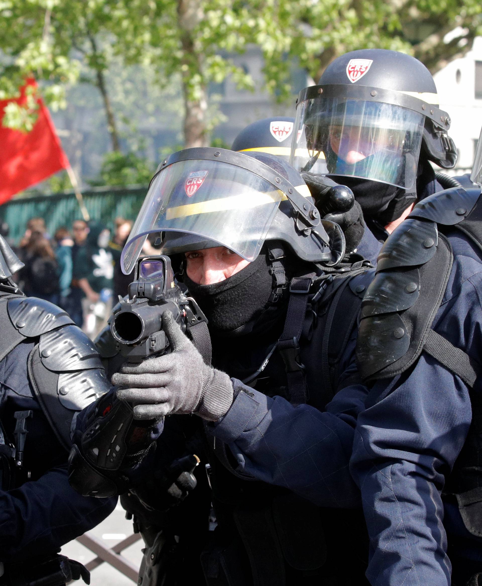 French CRS riot police secure a position during clashes with protesters at the May Day labour union rally in Paris