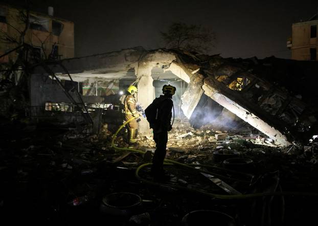An Israeli firefighter works to put out a fire after Iranian missile barrages struck Dimona, amid the U.S.-Israel conflict with Iran, in southern Israel