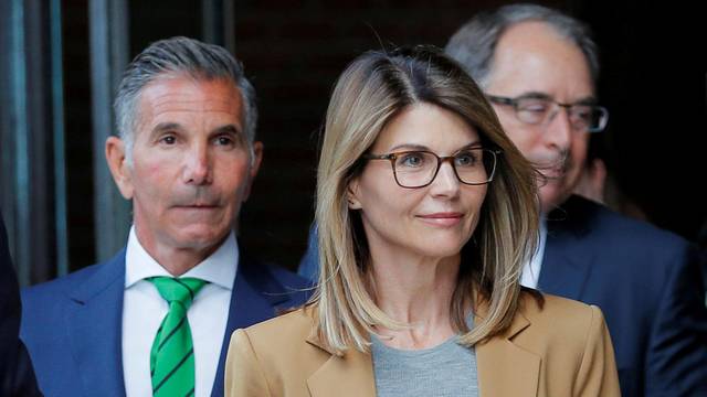 FILE PHOTO: Actor Lori Loughlin and her husband Mossimo Giannulli leave the federal courthouse in Boston