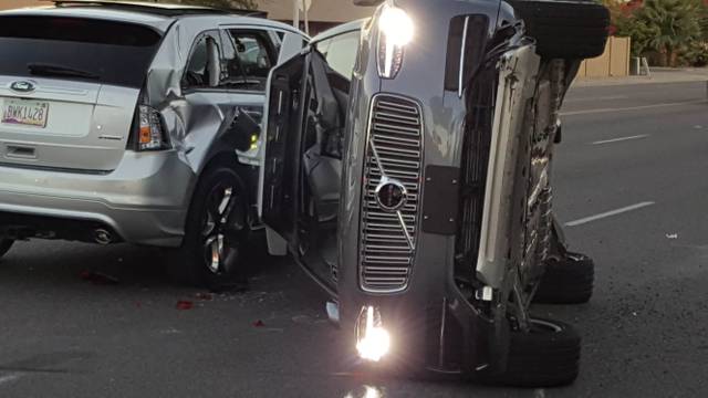 A self-driven Volvo SUV owned and operated by Uber Technologies Inc. is flipped on its side after a collision in Tempe