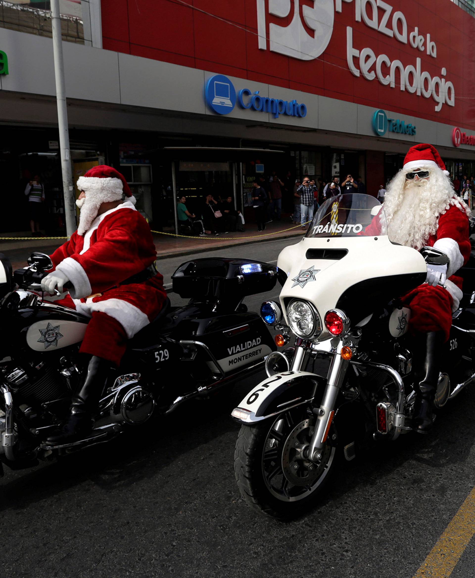 Members of the transit police dressed as Santa Claus ride their motorcycles in downtown Monterrey