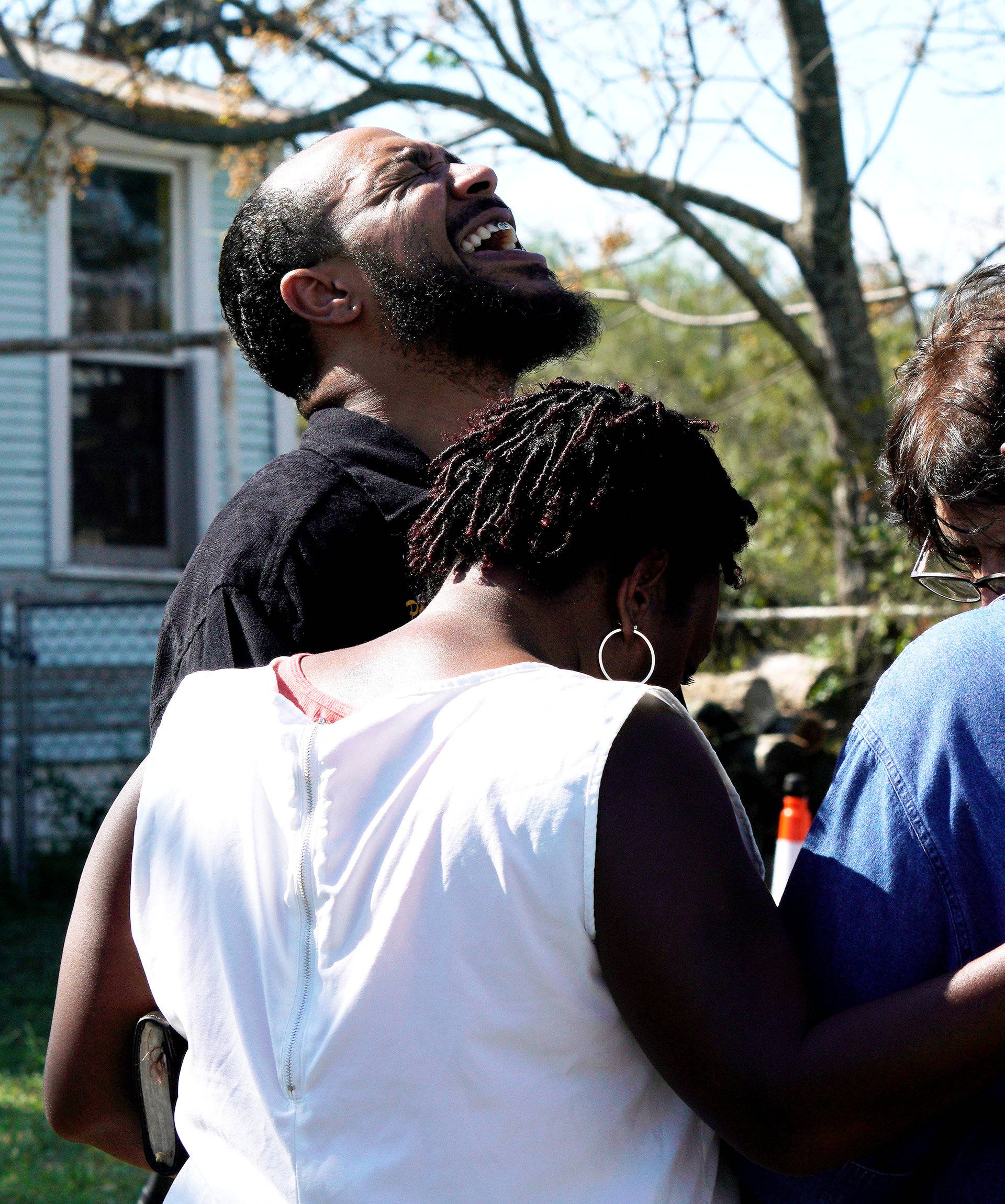 Pastor Oscar Dean prays with others near the site of the shooting at the First Baptist Church of Sutherland