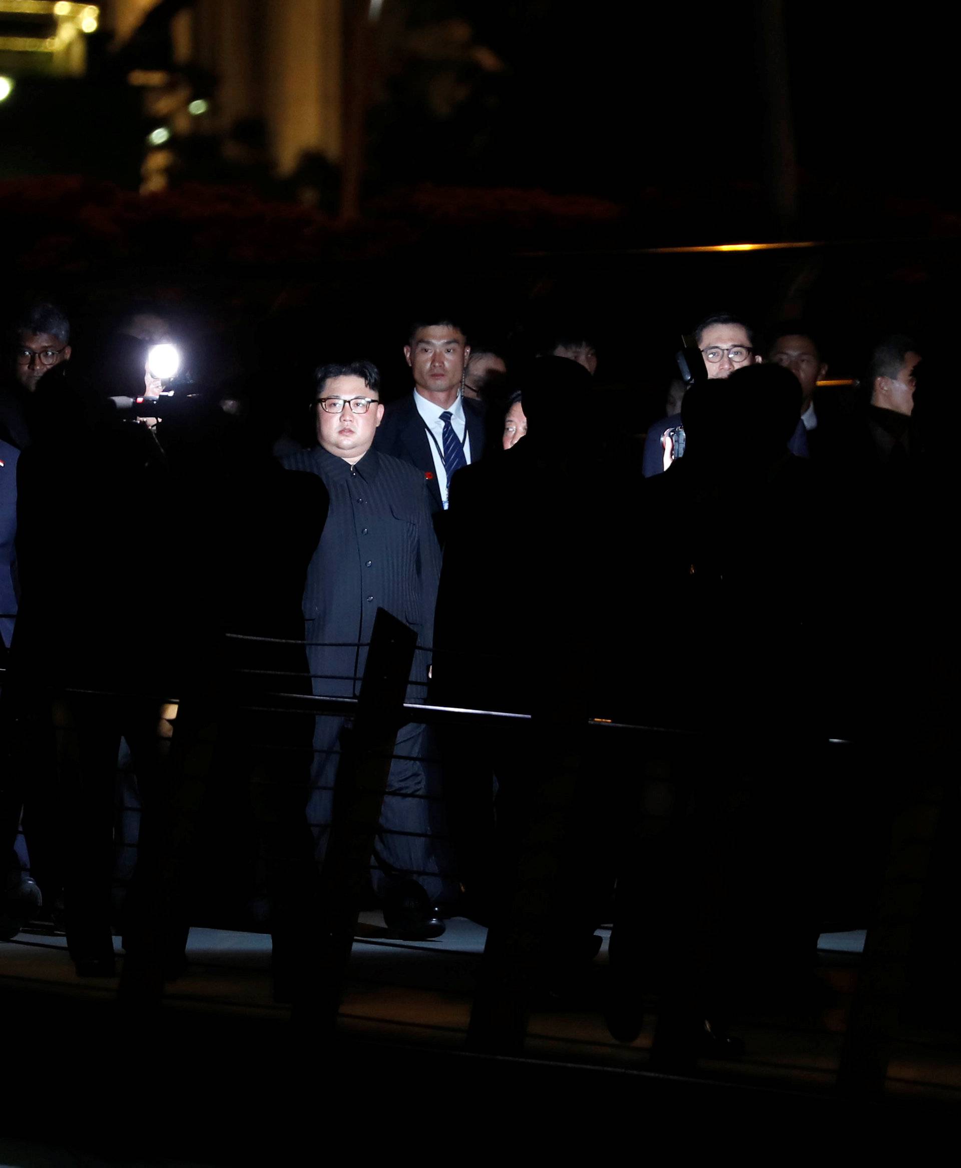 North Korea's leader Kim Jong Un is surrounded by guards as he visits Merlion Park in Singapore