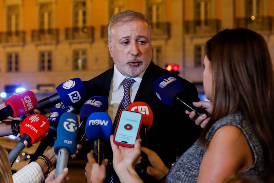 First responders work at the site of a funicular accident in Lisbon