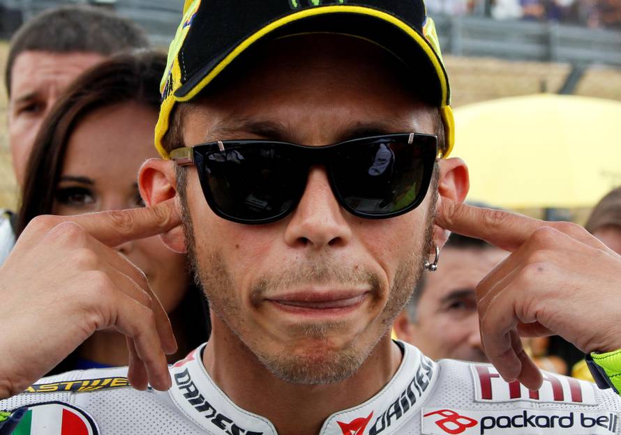 FILE PHOTO: Yamaha MotoGP rider Rossi of Italy puts in ear plugs before start of German Grand Prix at Sachsenring circuit near Hohenstein-Ernstthal
