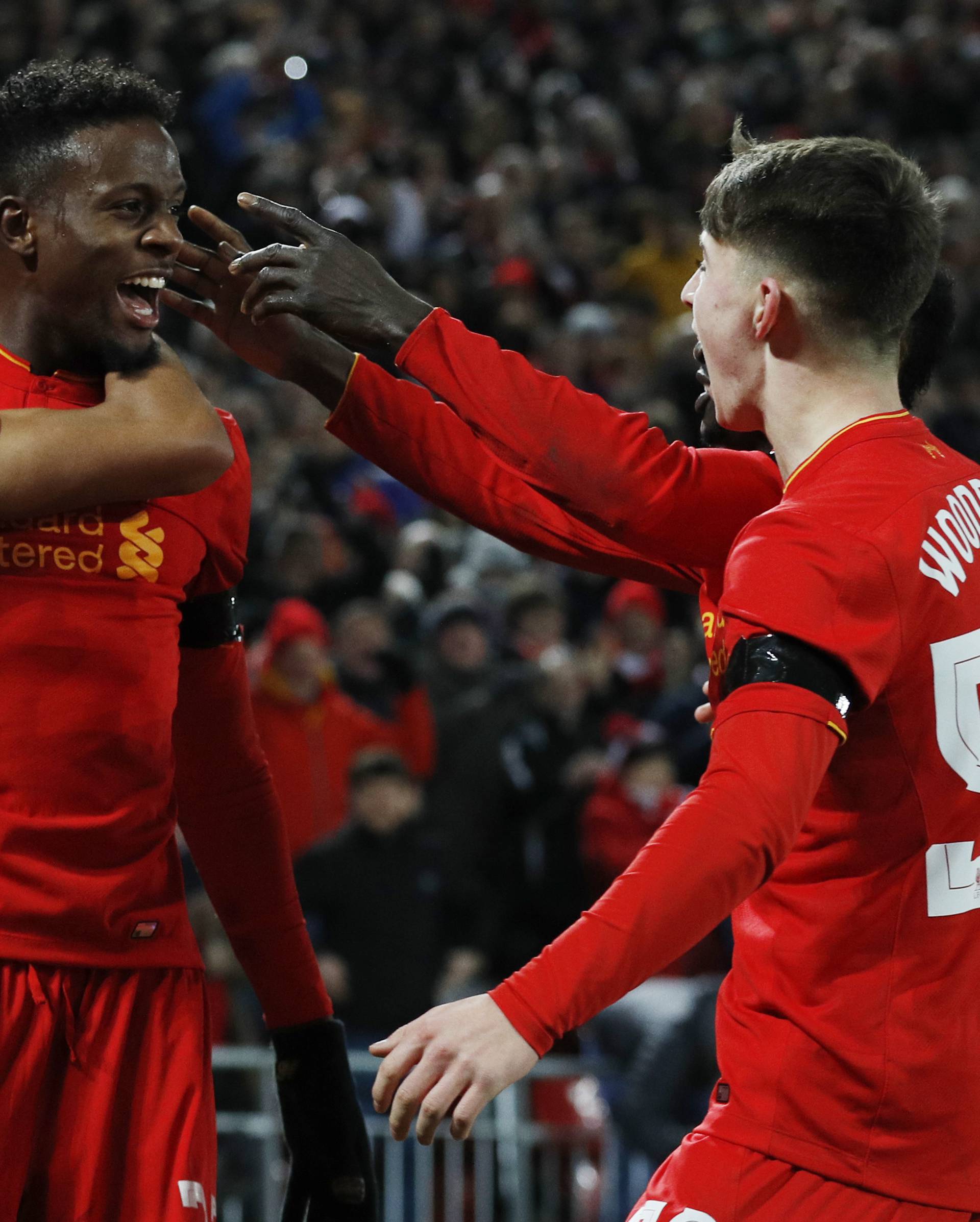 Liverpool's Divock Origi celebrates scoring their first goal with Ben Woodburn and Trent Alexander-Arnold