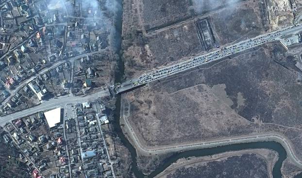 A satellite image shows the Irpin river bridge backup of cars in Irpin
