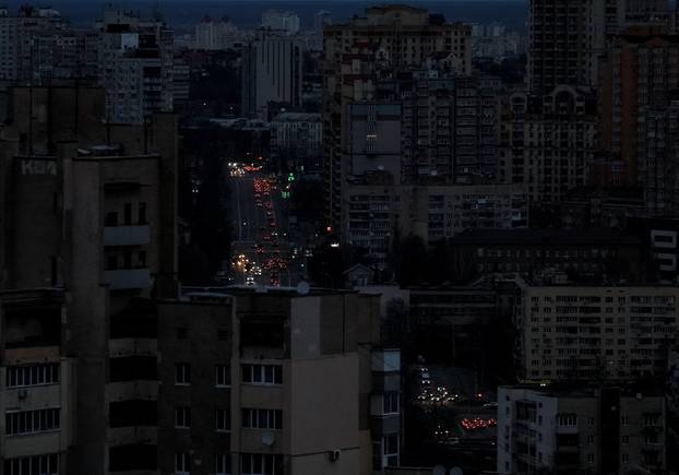 Traffic moves through the city centre during a blackout after civil infrastructure was hit by Russian drones and missile attacks, in Kyiv
