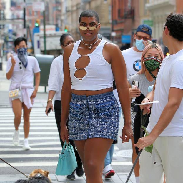 TV personality Earvin "EJ" Johnson III is seen in a knit skirt, blue sneakers, white tank top and blue bag in New York City