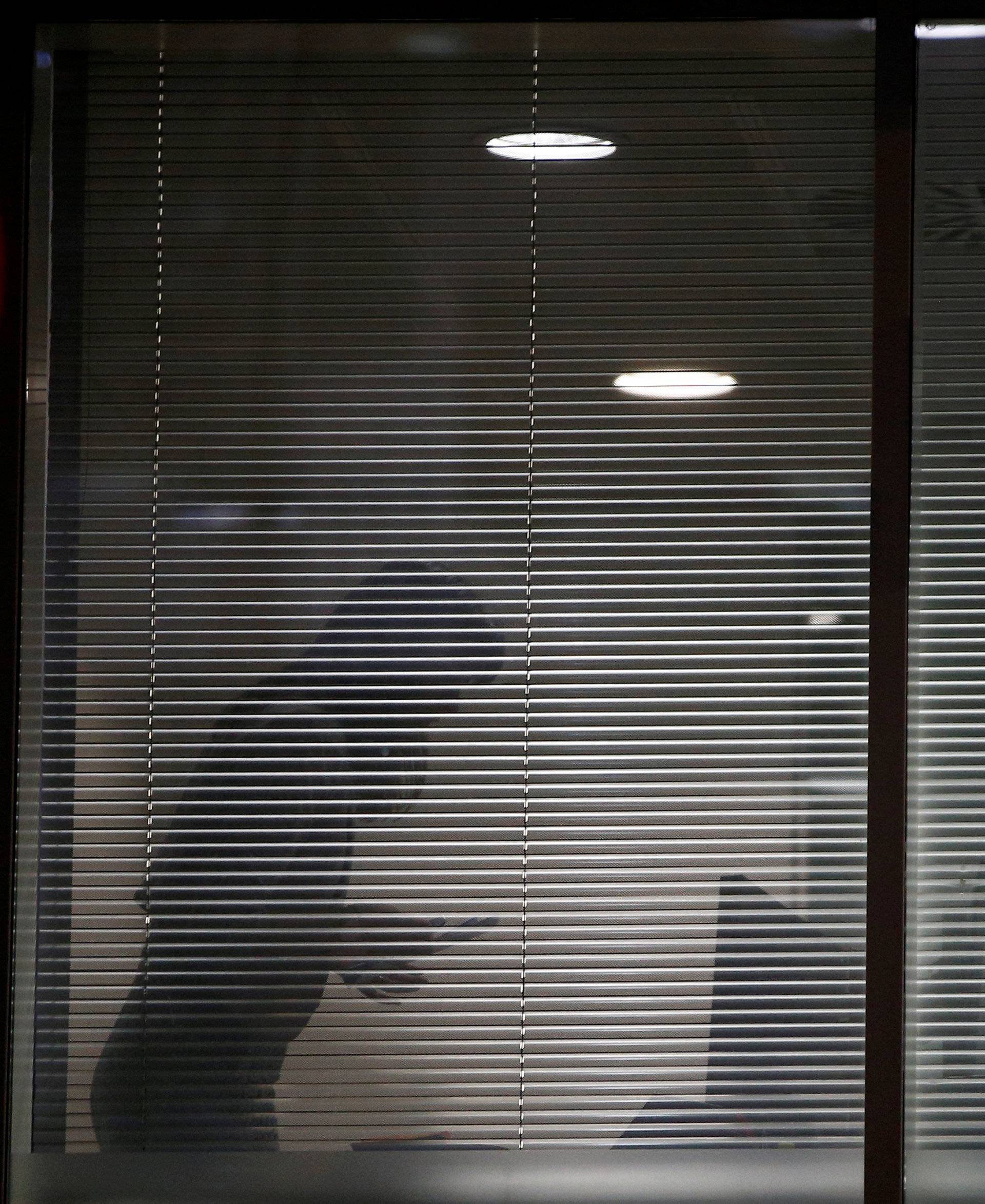 An investigator from Britain's Information Commissioners Office, is seen inside the building which houses the offices of Cambridge Analytica as investigators in London