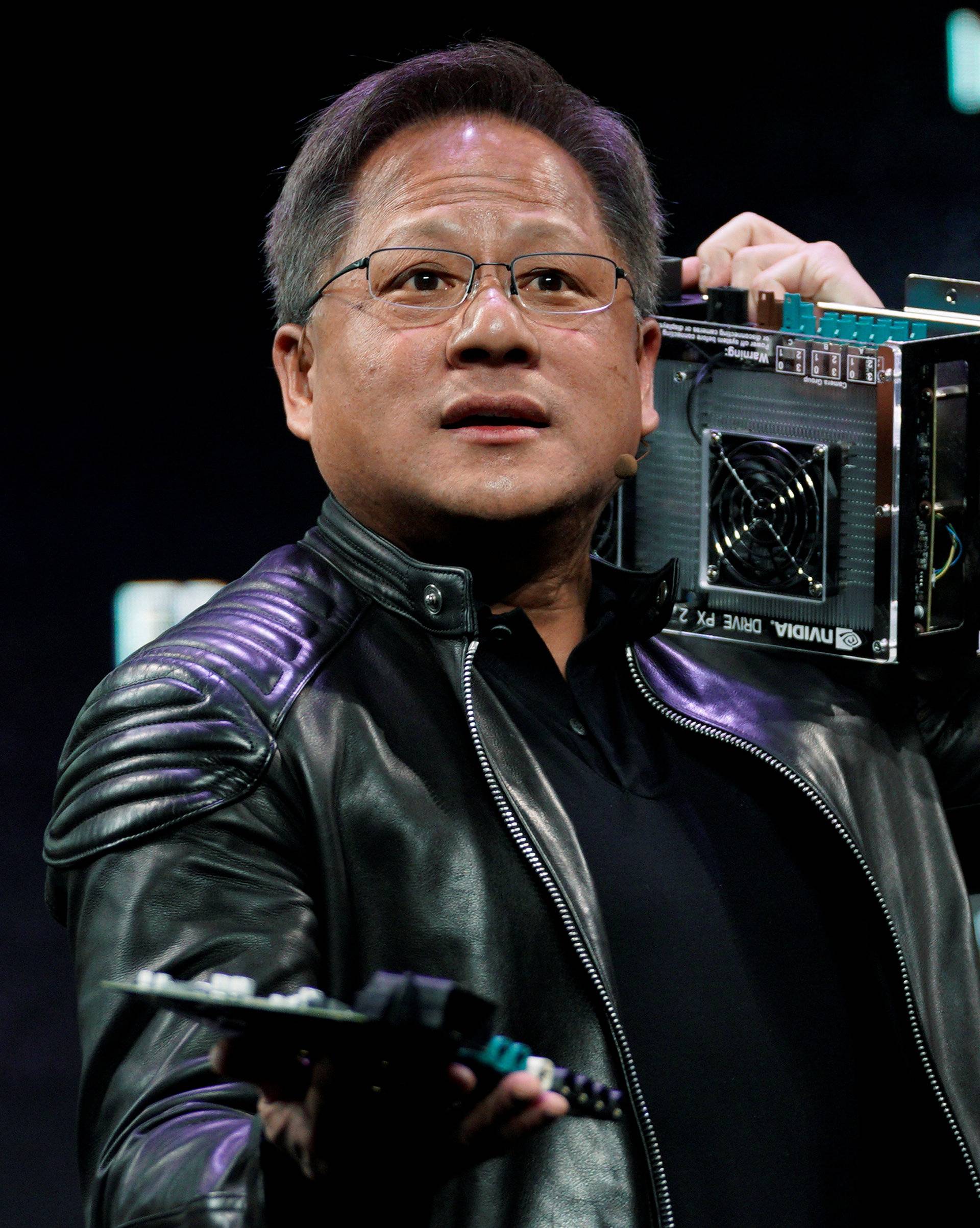 Jensen Huang, CEO of Nvidia, shows the old and new computers for autonomous vehicles at his keynote address at CES in Las Vegas