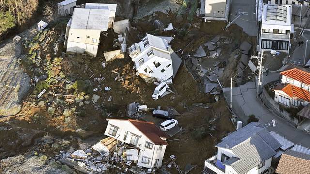 An aerial view shows collapsed houses, cars and roads caused by an earthquake in Kanazawa